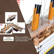Wooden model ship of the Titanic with lights on a brown background