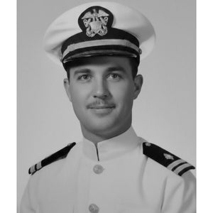 Black and white portrait of a man in naval uniform with a cap.